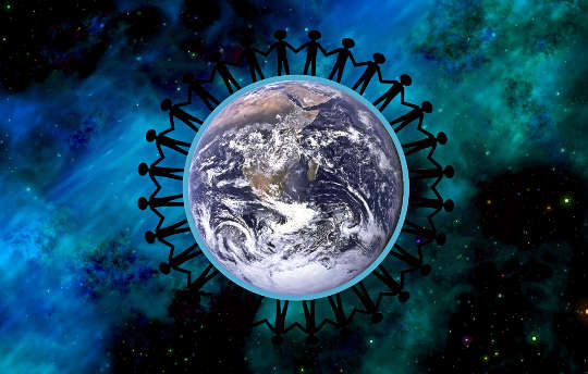 The Power of All in Community for the Greatest Good a circle of people holding hands encircling Planet Earth
