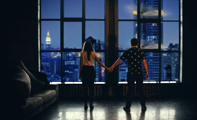 Why Couples Don't Get Help a couple standing far apart but holding hands