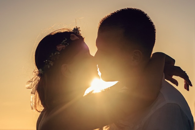 Finding Joy: A Meeting of Soulmates two people kissing with the light shining brightly behind them