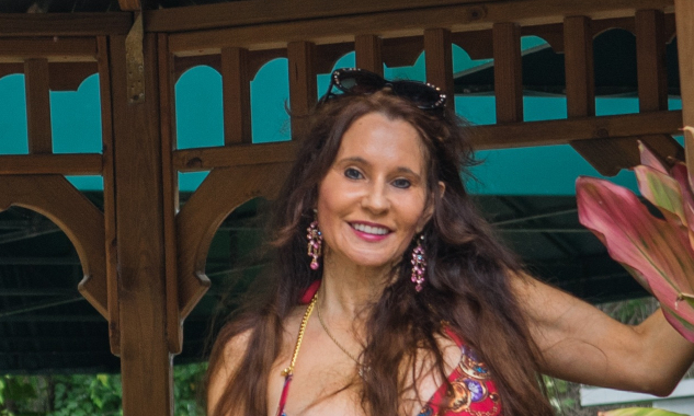 woman with long beautiful hair standing in a gazebo