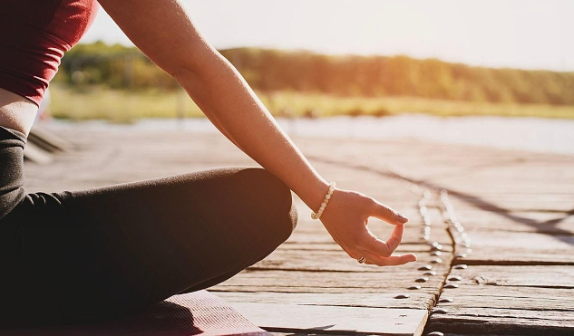 a person meditation with hands in a mudra pose