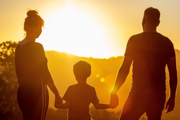 Waking Up To Our Pure Heart Will Shape Earth's Destiny A family standing holding hands in front of the rising sun. Image by s05prodpresidente from Pixabay.
