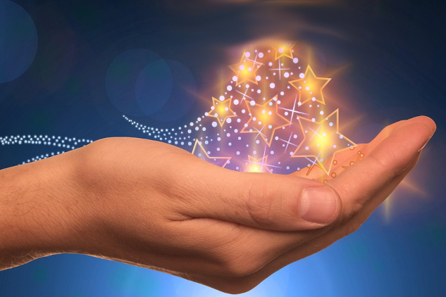 A hand holding light and stars. Image by Gerd Altmann from Pixabay