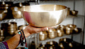 hands holding a large singing bowl